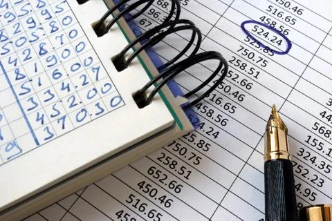 Note with financial data and pen. Accounting concept. Stock Photos