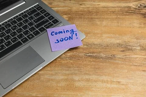 Note on laptop indicates upcoming project or event announcement Stock Photos