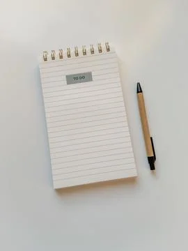 Note pad clean page with to do list sticker and pen on white table Stock Photos