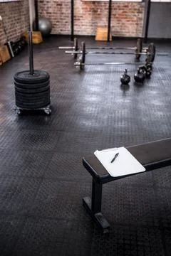 Note pad on weight bench in gym Stock Photos
