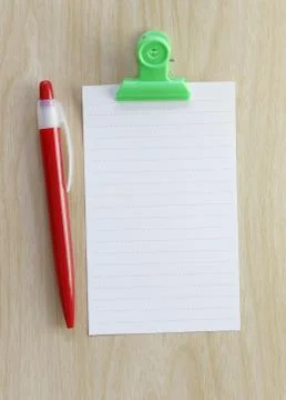 Note paper and red pen placed on wooden floor. Stock Photos
