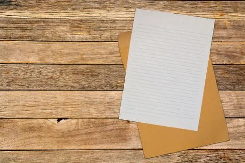 Note Paper with Brown Envelope over Wood Blackground Stock Photos