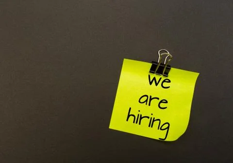 Note with a paper clip on black background . hiring vacant - Image Stock Photos