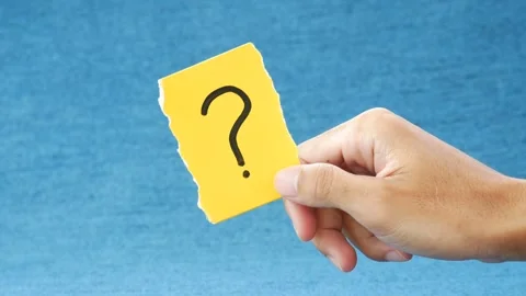 Note paper in hand holds paper with a question mark Stock Footage 268912337