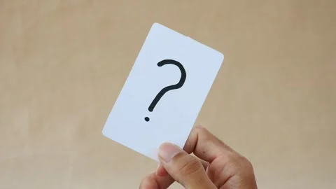 Note paper in hand holds paper with a question mark Stock Footage 268912358