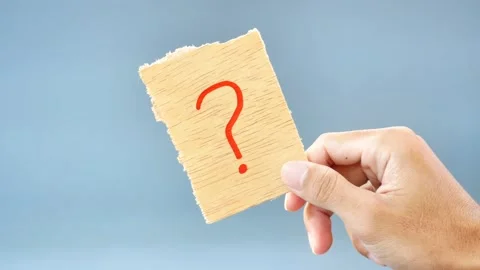 Note paper in hand holds paper with a question mark Stock Footage 268912359