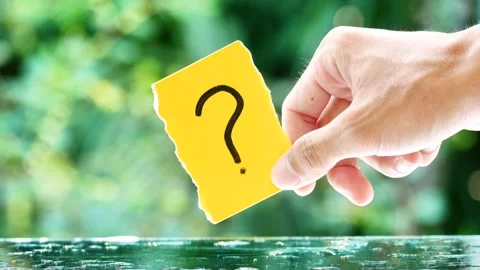 Note paper in hand holds paper with a question mark Stock Footage 268913094