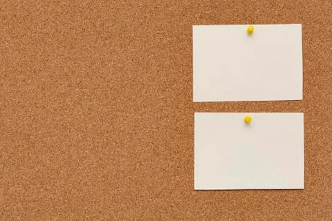 Note paper swith push pins on cork board. Empty paper pages for notes copy sp Foto stock