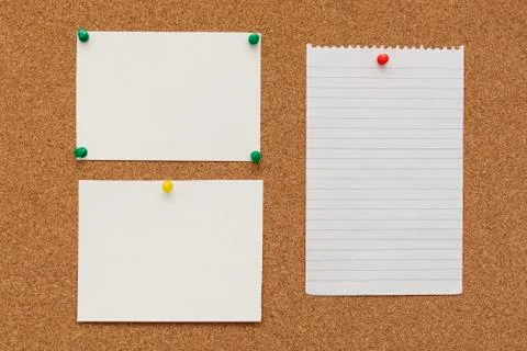 Note paper swith push pins on cork board. Empty paper pages for notes copy sp Stock-Fotos