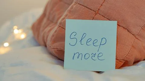 Note on pillow with handwritten message about sleep and cozy bedding Stock Photos