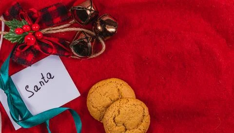 Note to Santa on a red background with bells and cookies, Christmas concept Stock Photos