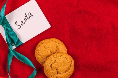 Note to Santa on red background with cookies, Christmas concept Stock Photos