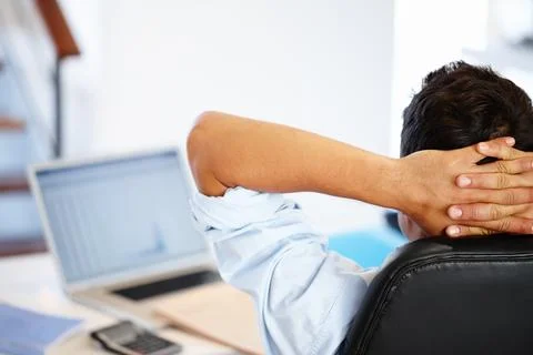 Note to self Relax. Rear view of a businessman taking a break from his work Stock Photos