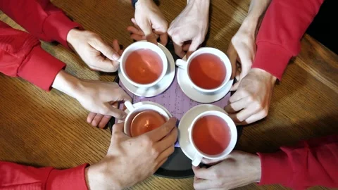 Note sheet under cups of fruit tea. close-up of male hands taking out cups of Stock Footage 265422874