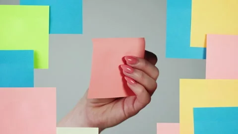 Note sticker on transparent glass close-up. Working in office, creative designer Video stock 182013014