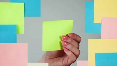 Note sticker on transparent glass close-up. Working in office, creative designer Stock Footage 182015366