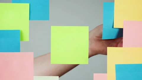 Note sticker on transparent glass close-up. Working in office, creative designer Stock Footage 182019522