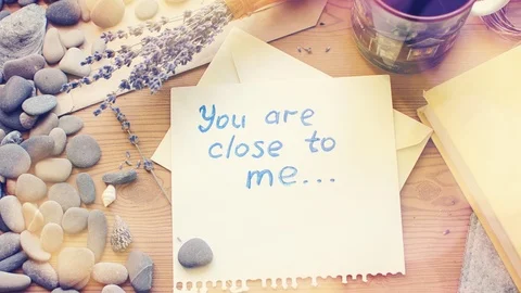 Note on the table: You are close to me. Romantic vintage composition. Stock Footage 98140097