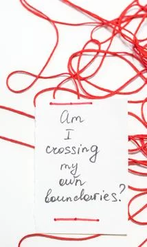 Note on white paper surrounded by tangled red thread on a light background Stock Photos