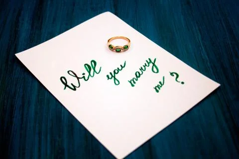 Note "will you marry me" and  engagement ring Stock Photos