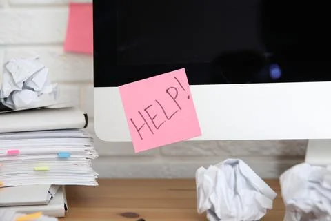 Note with word Help and stationery on computer at workplace Stock Photos