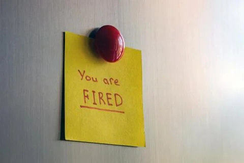 A note you are fired attached with a magnet to the refrigerator. Stock Photos