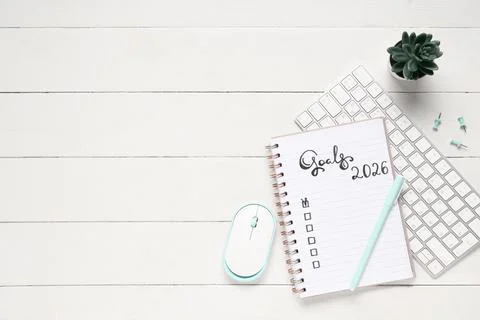 Notebook with 2026 goals and computer keyboard on white wooden background Stock Photos