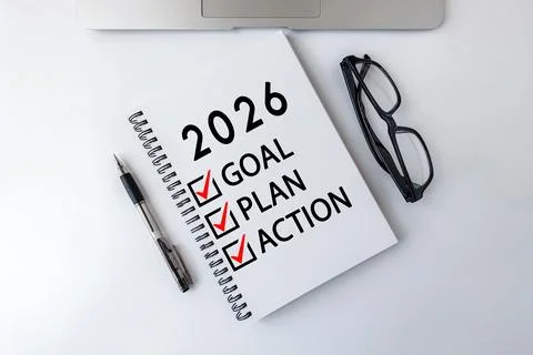 Notebook with 2026 goals, plan, and action checklist on white desk Stock Photos