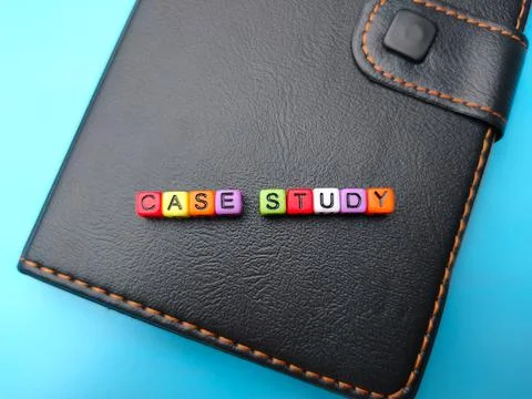 Notebook and colored word with text CASE STUDY on a blue background. Stock Photos