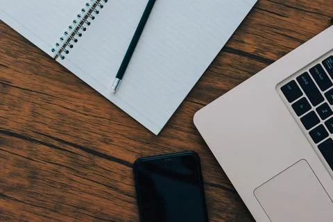 Notebook and computer on brown wood floor Stock Photos