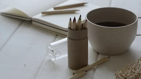 Notebook and cup of coffee on white table with panning. 스톡 동영상 82344822