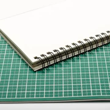 Notebook and cutting mat Stock Photos