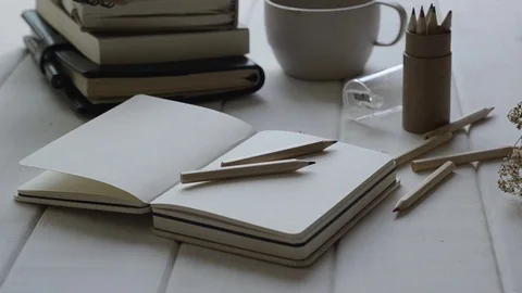 Notebook and diary on white table with panning. Stock-Footage 82344849