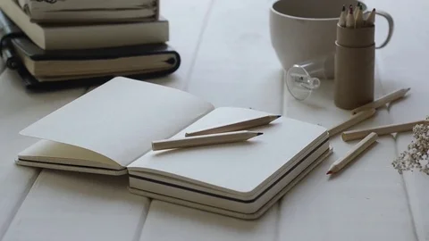 Notebook and diary on white table with panning. 스톡 동영상 82345233