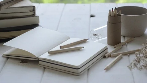 Notebook and diary on white table with panning. Stock Footage 82345511