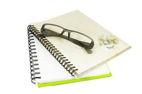 Notebook and eyeglasses Stock Photos