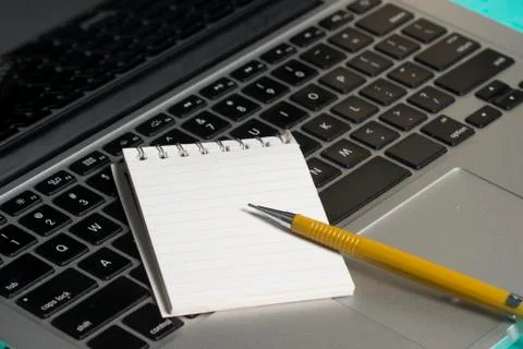 Notebook and a paper note Stock-Fotos