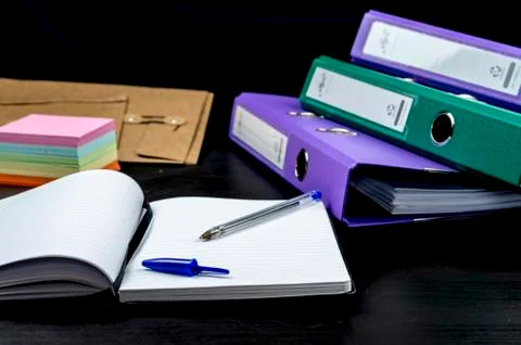 Notebook and paperwork on desk Stock Photos