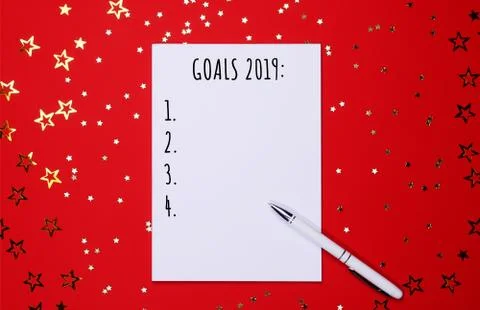 Notebook and pen on background of star-shaped confetti. Stock Photos