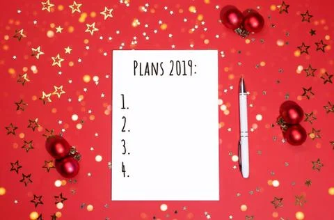 Notebook and pen on background of star-shaped confetti. Stock Photos