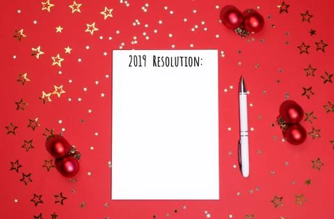 Notebook and pen on background of star-shaped confetti. Stock Photos
