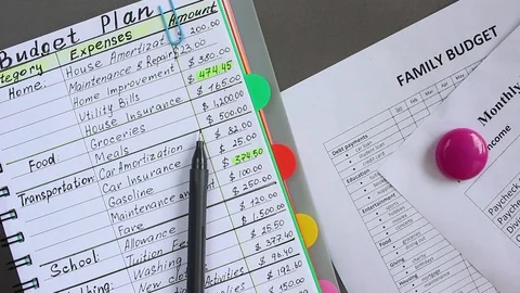 The Notebook and Pen: This is the oldest method for budgeting Stock Footage 93493843