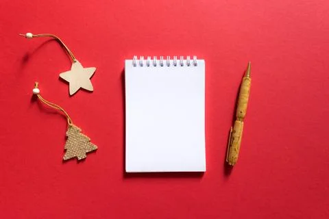 Notebook and pen on a red background, spiral notepad with christmas tree and  Stock Photos