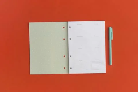 Notebook and pen on red background. Top view. Flat lay. Back to school concep Stock Photos