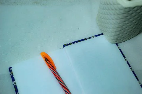 Notebook and Pen with Small White Pot on Clean White Background Stock Photos