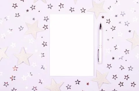 Notebook and pen on white background with stars. Stock Photos