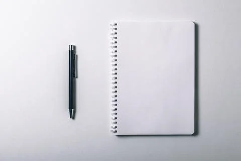 Notebook and pen on white background. Top view and copy space. Blank notebo.. Stock Photos