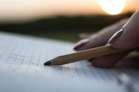 Notebook and pencil in the hands Stock Photos