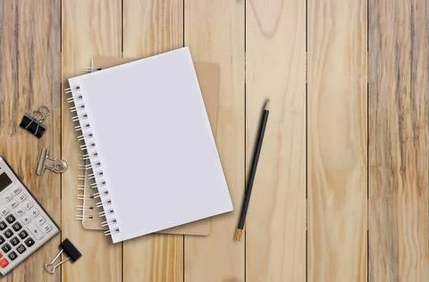 Notebook and pencil Set on a brown wooden floor. Stock Photos