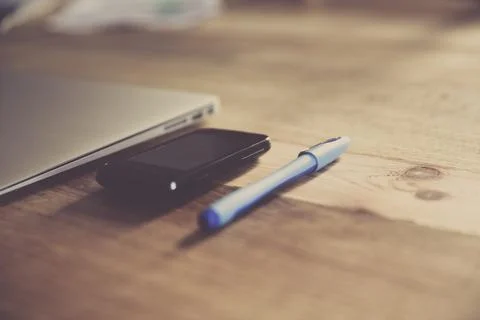 Notebook and phone on a table Stock Photos